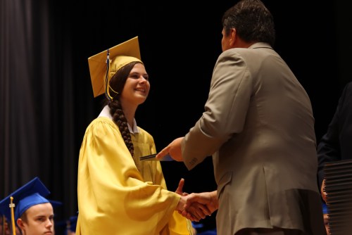 Receiving her diploma.